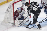 Colorado Avalanche goaltender Philipp Grubauer, left, blocks a shot by Los Angeles Kings left wing Carl Grundstrom during the first period of an NHL hockey game Tuesday, Jan. 19, 2021, in Los Angeles. (AP Photo/Kyusung Gong)
