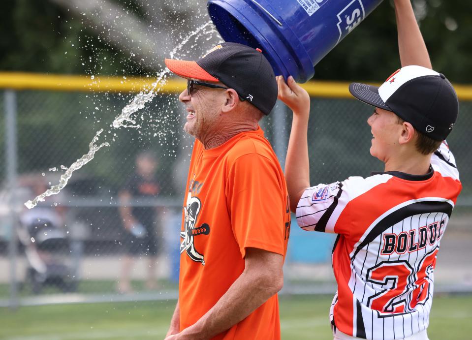 Middleboro 12U Nationals Luke Bolduc pours a cooler of water on Skeeter Porter after game versus Wellesley at Dunn Little League Complex at Hollingsworth Park in Braintree on Sunday, July 31, 2022.   