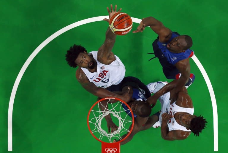 USA's centre DeAndre Jordan (L) aims for the basket during a Group A basketball match against France at the Rio 2016 Olympic Games