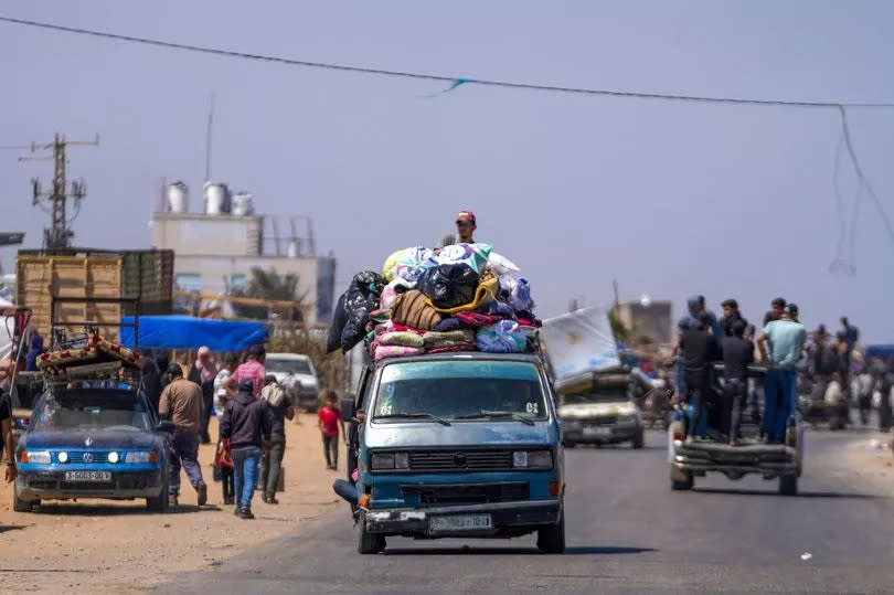 Displaced Palestinians arrive in central Gaza after fleeing from the southern Gaza city of Rafah in Deir al Balah, Gaza Strip, on Thursday, May 9, 2024. The Israeli army has ordered tens of thousands of people to evacuate Rafah as it conducts a ground operation there.