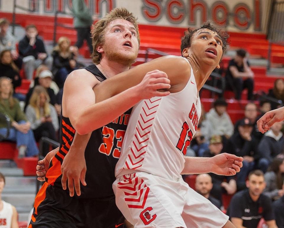 Brighton's Ben Anderson (33) was often asked to defend taller opponents, like Canton's Dante Favor (12).