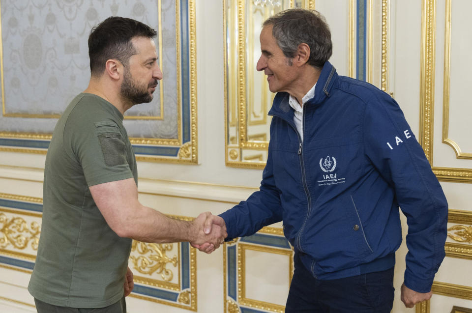 In this photo provided by the Ukrainian Presidential Press Office, Ukrainian President Volodymyr Zelenskyy, left, shakes hands with International Atomic Energy Agency (IAEA) Director General Rafael Mariano Grossi during their meeting in Kyiv, Ukraine, Thursday, Oct. 6, 2022. (Ukrainian Presidential Press Office via AP)