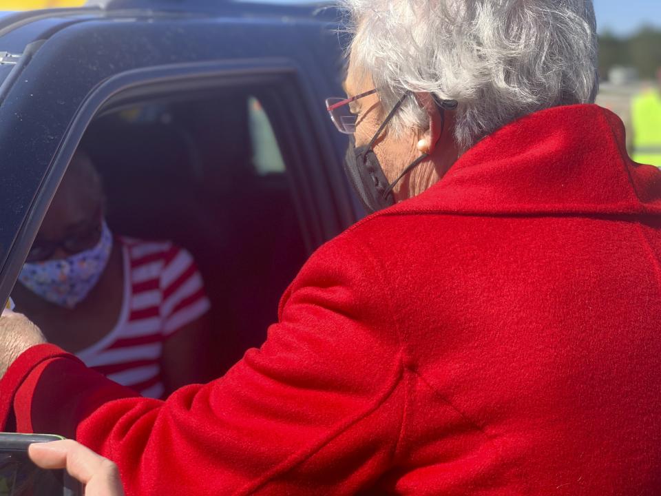 Alabama Gov. Kay Ivey hands a vaccination sticker to Doris Coleston after Coleston received a COVID-19 vaccination at a clinic in Camden, Ala. on Friday, April 2, 2021. (AP Photo/Kim Chandler)