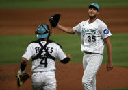 Miami Marlins relief pitcher A.J. Puk (35) celebrates with catcher Nick Fortes (4) after defeating the New York Mets, Friday, March 31, 2023, in Miami. (AP Photo/Michael Laughlin)