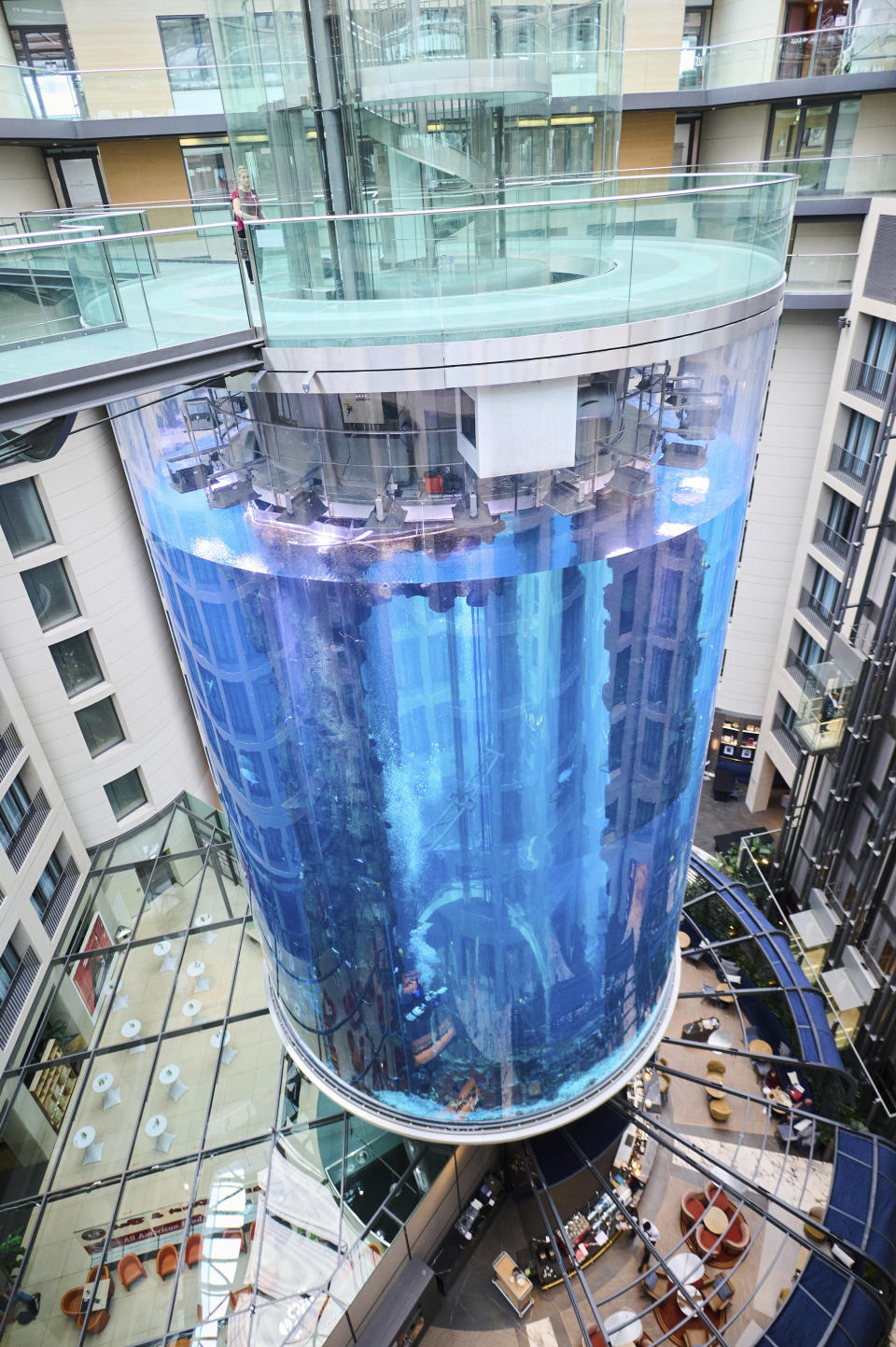 The AquaDom aquarium at the Sea Life tourist attraction photographed in Berlin, Wednesday, June 1, 2022. The aquarium is bursts on Friday, Dec. 16, 2022. Operators say the aquarium has the biggest cylindrical tank in the world. It contained 1,500 tropical fish before the incident. (Annette Riedl/dpa via AP)