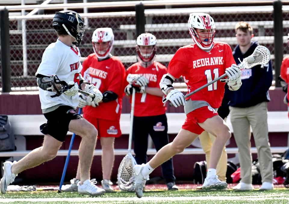 Natick's Quinn Pinkham sprints for the Hingham net In second day action at the Coaches Cup Lacrosse Challenge at Concord-Carlisle High School, April 21, 2022.  