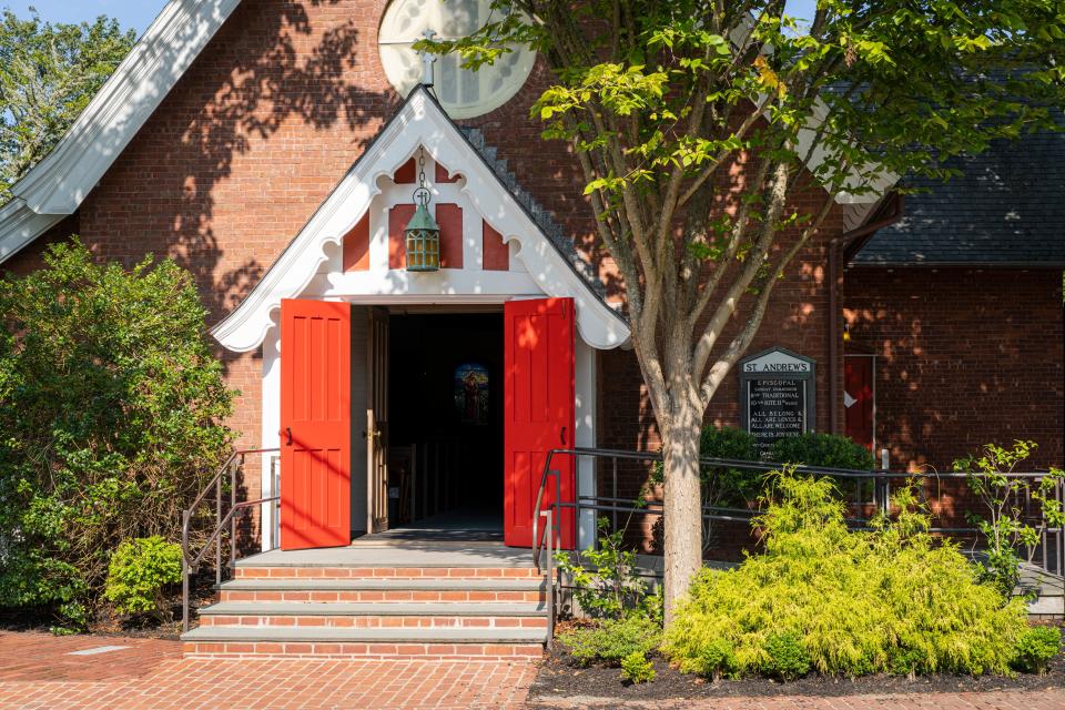 A church with its bright red doors seen open.