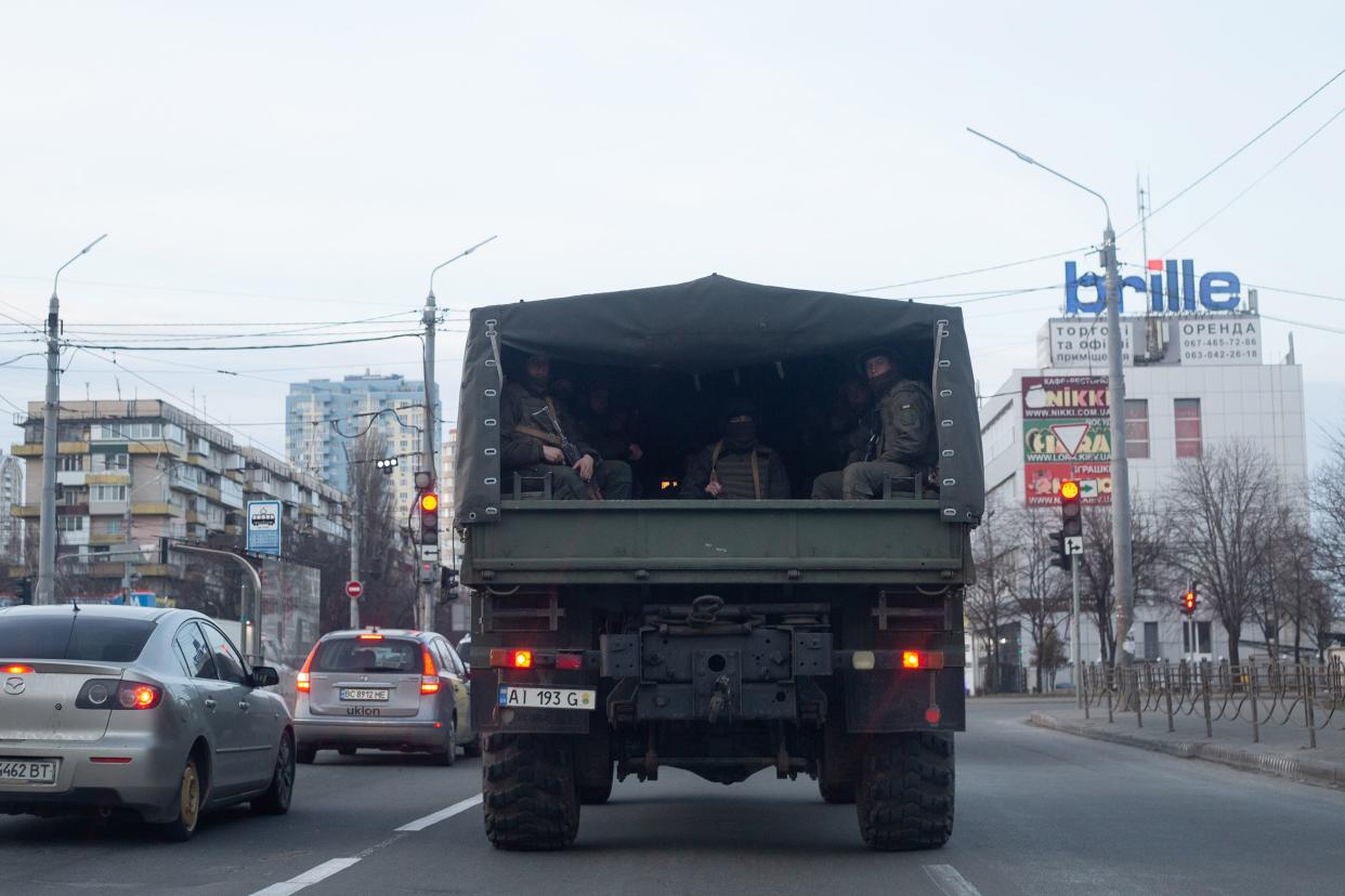 A military vehicle with Ukrainian servicemen drives through the road on Feb. 25, 2022, in Kyiv, Ukraine. Yesterday, Russia began a large-scale attack on Ukraine, with Russian troops invading the country from the north, east and south, accompanied by air strikes and shelling. The Ukrainian president said that at least 137 Ukrainian soldiers were killed by the end of the first day.