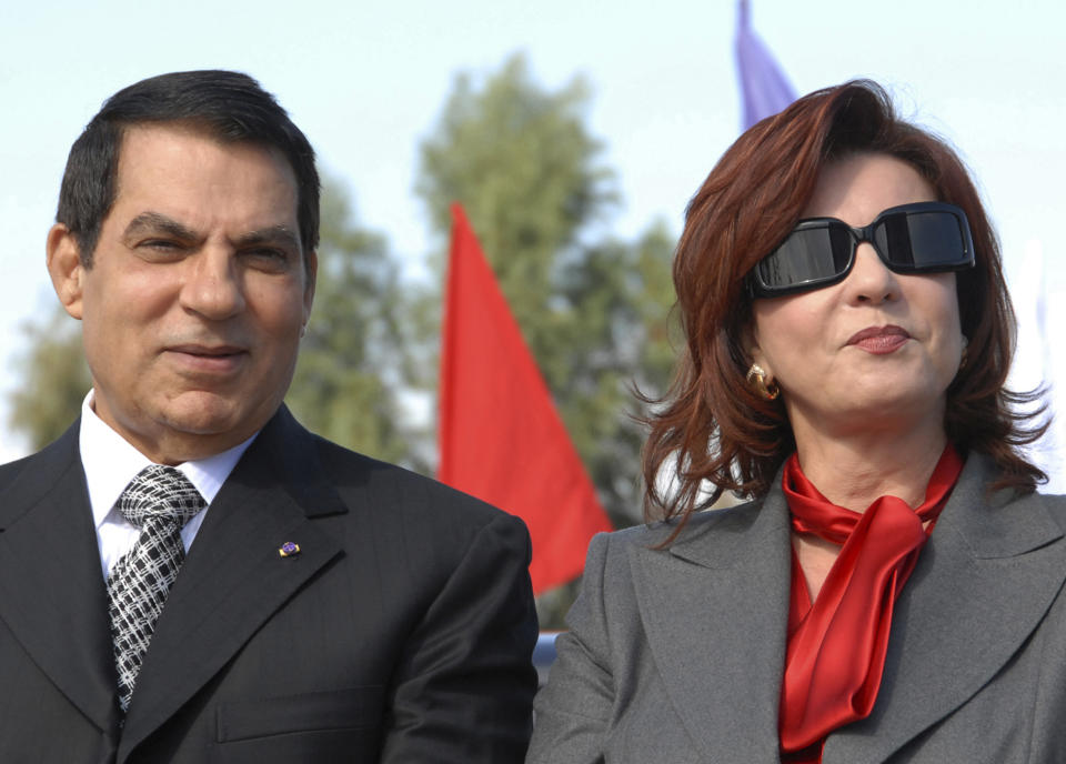 FILE - In this Nov. 7, 2007 file photo, Tunisian President Zine EL Abidine Ben Ali and his wife Leila mark the 20th anniversary of Ben Ali's presidency, in Rades, outside Tunis. Since winning a parliamentary seat in 2019, Tunisian lawmaker Abir Moussi has become one of the country’s most popular, and most controversial, politicians, riding a wave of nostalgia for a more stable and prosperous time, just as Tunisia marks 10 years since protesters overthrew autocratic former President Zine El Abidine Ben Ali. Since 2011, Tunisia has been plagued by sinking wages, growing joblessness and worsening public services. Unemployment has risen amid the coronavirus pandemic from 15% to 18%. Attempts to migrate to Europe by sea have soared. (AP Photo/Hassene Dridi, File)