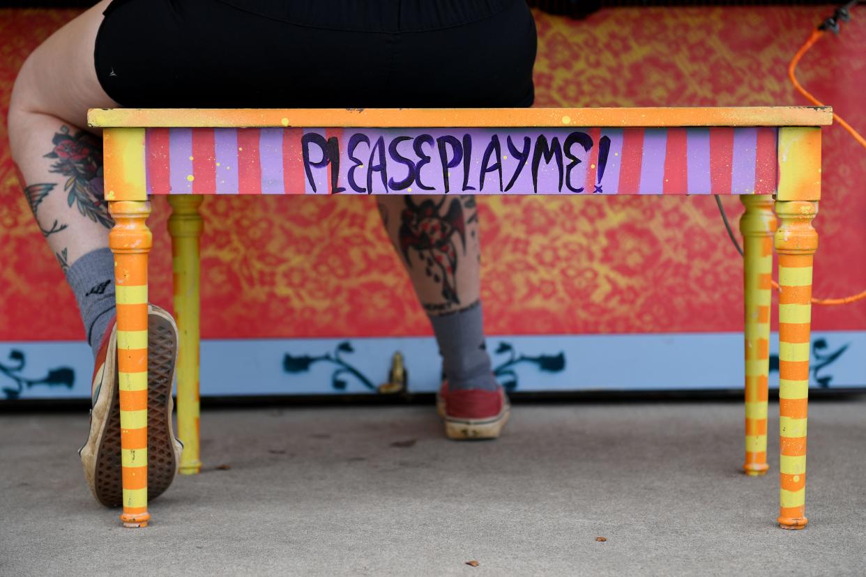 Darby Wilcox, local musician, plays the Please Play Me Piano, named Howard the Piano, located at Swamp Rabbit Cafe while she waits for her order on Tuesday, June 18, 2024. The piano was painted by Crosby Jack.