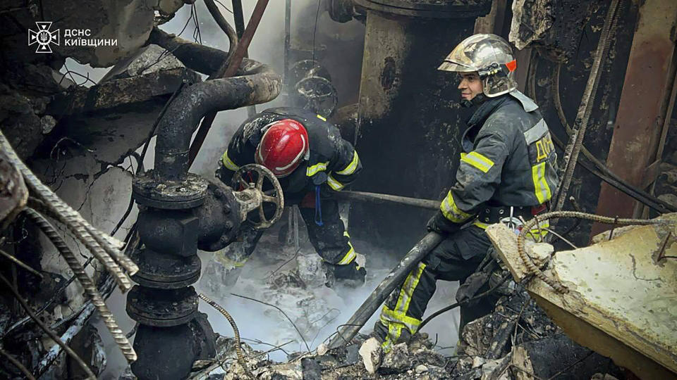 In this photo provided by the Ukrainian Emergency Service, emergency workers extinguish a fire after a Russian attack on the Trypilska thermal power plant in Ukrainka, Kyiv region, Ukraine, Thursday, April 11, 2024. (Ukrainian Emergency Service via AP)