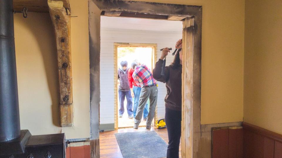 Students from Holland College working on expanding the doorways at Green Gables house. 