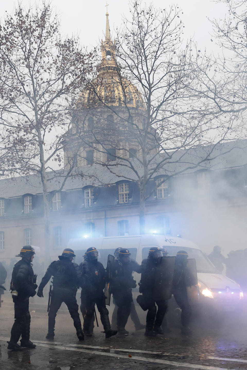 Riot police officer take position in front of the Invalides dome after a yellow vest demonstration Saturday, Jan. 19, 2019 in Paris. Thousands of yellow vest protesters rallied Saturday in several French cities for a 10th consecutive weekend, despite a national debate launched this week by President Emmanuel Macron aimed at assuaging their anger. (AP Photo/Thibault Camus)