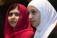 Nobel Peace Prize winner Malala Yousafzai (L) and 17-year-old Syrian refugee Mazoun Almellehan listen to speakers during the first focus event on education at the donors Conference for Syria in London, Britain February 4, 2016. REUTERS/Stefan Rousseau/pool