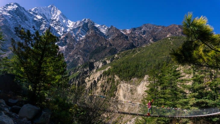 <span class="article__caption">Bridge crossings, prayer flags, and incredible Himalayan peaks are some of the sights along the Annapurna Circuit</span> (Photo: Courtesy Emily Pennington)