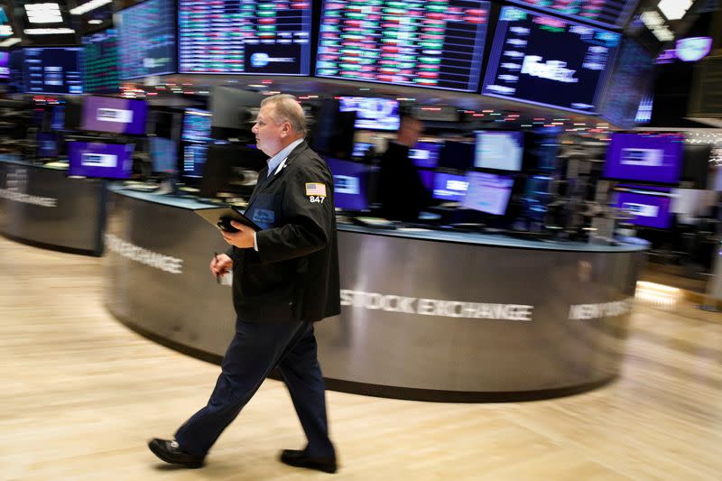 Traders work on the floor of the NYSE in New York