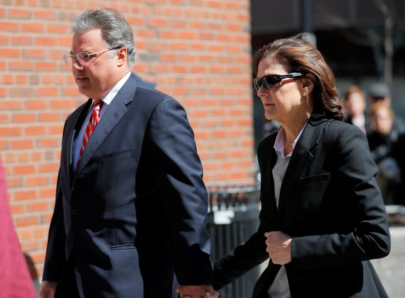 FILE PHOTO: Manuel and Elizabeth Henriquez, facing charges in a nationwide college admissions cheating scheme, enter federal court in Boston