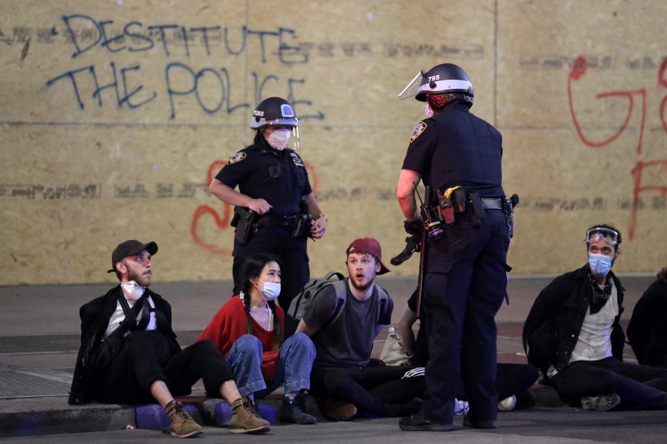 Police arrest a group of people after curfew in New York, Tuesday, June 2, 2020. New York City extended an 8 p.m. curfew all week as officials struggled Tuesday to stanch destruction and growing complaints that the nation's biggest city was reeling out of control night by night. (AP Photo/Seth Wenig)