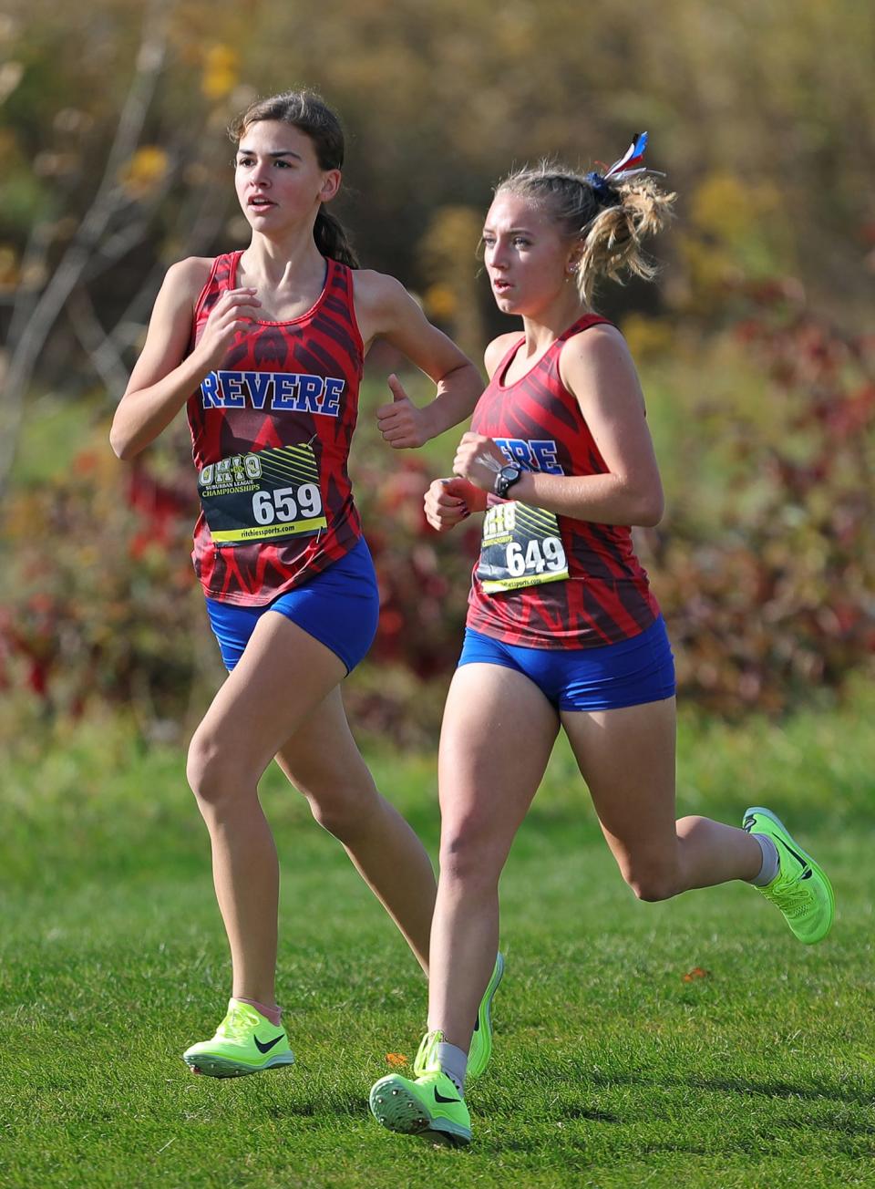 Revere’s Keira Lang, left, and Megan Diulus, right, run together during the Suburban League Cross Country Championships, Saturday, Oct. 15, 2022, in Norton, Ohio.