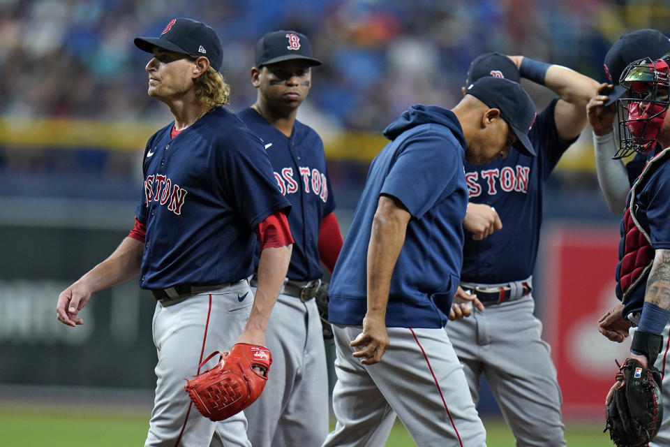 Boston Red Sox starting pitcher Garrett Richards, left, is taken out of the game by manager Alex Cora, center, during the second inning of a baseball game Wednesday, June 23, 2021, in St. Petersburg, Fla. (AP Photo/Chris O'Meara)