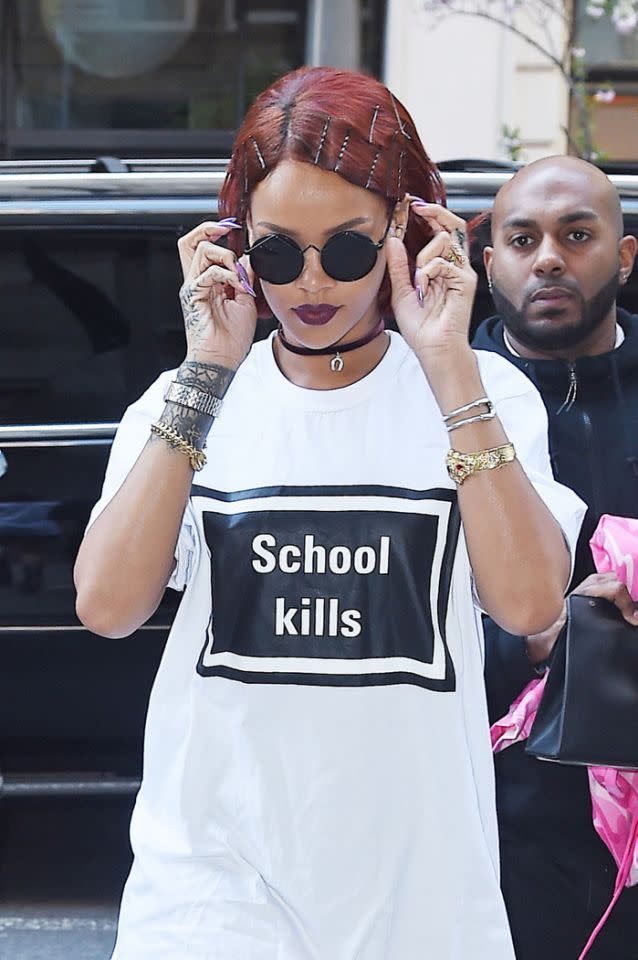 Rihanna makes a bold statement in a white and black shirt.