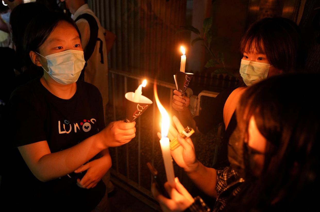 People light candles at Victoria Park on the 32nd anniversary of the crackdown on pro-democracy demonstrators at Beijing's Tiananmen Square in 1989, in Hong Kong, China 4 June 2021 (REUTERS)