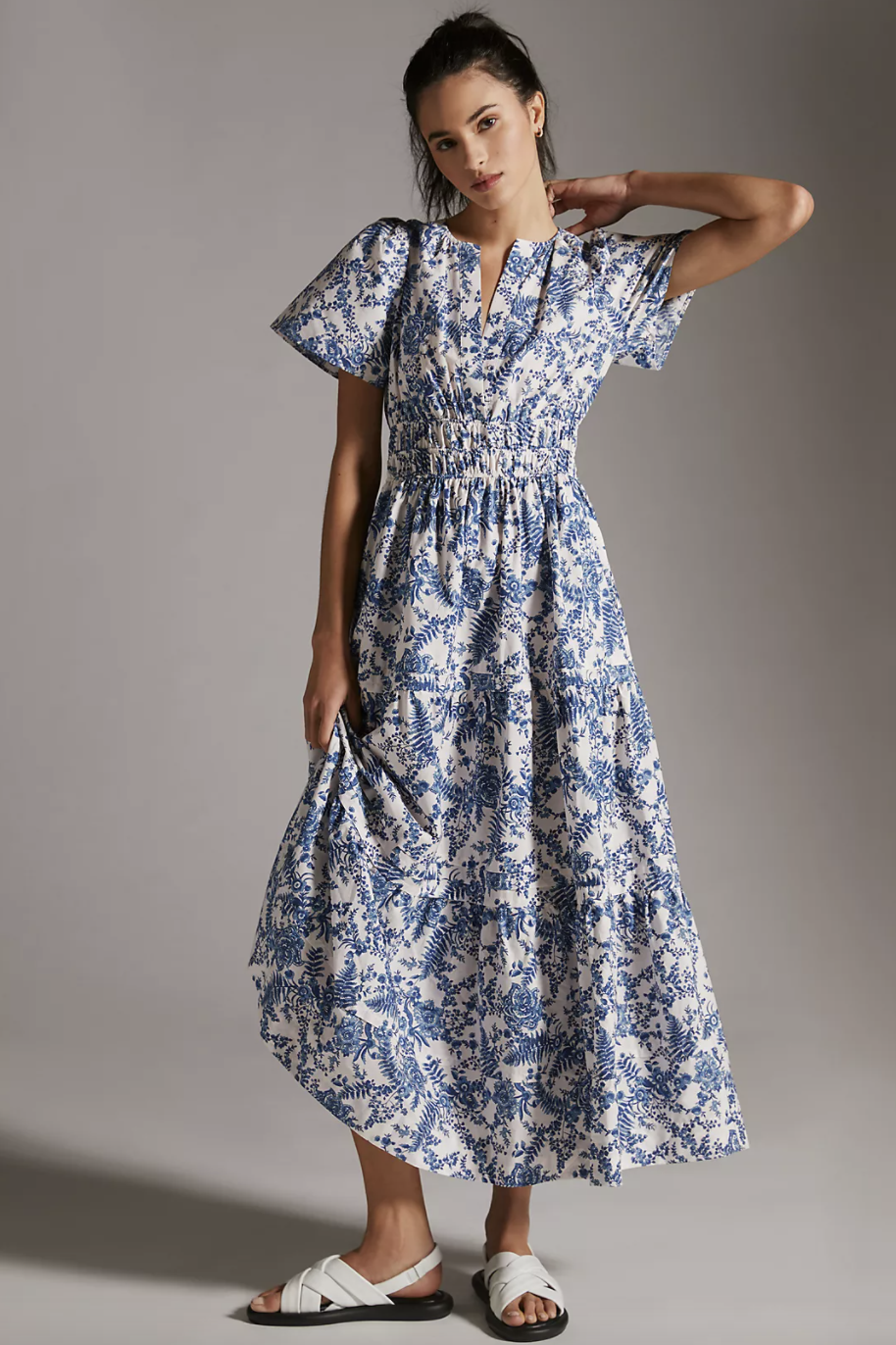brunette model in white sandals and blue and white floral Anthropologie Somerset Maxi Dress (Photo via Anthropologie)