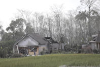 A man inspects the damage at his home in an area affected by the eruption of Mount Semeru in Lumajang, East Java, Indonesia, Sunday, Dec. 5, 2021. The highest volcano on Indonesia’s most densely populated island of Java spewed thick columns of ash, searing gas and lava down its slopes in a sudden eruption triggered by heavy rains on Saturday. (AP Photo/Trisnadi)