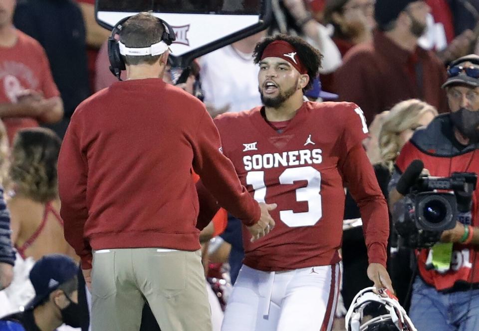 Oklahoma quarterback Caleb Williams celebrates with head coach Lincoln Riley.