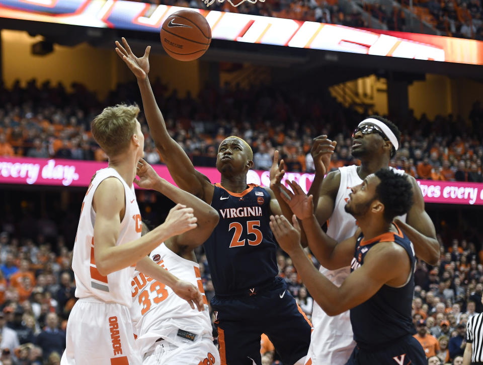 Virginia forward Mamadi Diakite (25) reaches for a rebound during the first half of an NCAA college basketball game against Syracuse in Syracuse, N.Y., Monday, March 4, 2019. (AP Photo/Adrian Kraus)