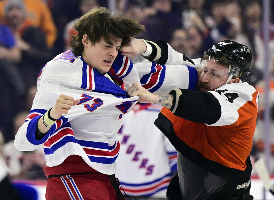 FILE - Philadelphia Flyers' Nicolas Deslauriers (44) and New York Rangers' Matt Rempe (73) fight during the first period of an NHL hockey game Feb. 24, 2024, in Philadelphia. Rempe fought seconds into his first NHL shift. Rangers fans chant his name whether he is playing or not. The 6-foot-8 forward was a central figure in a rare line brawl. And at 21 he has become a modern-day cult hockey hero. (AP Photo/Derik Hamilton, File)