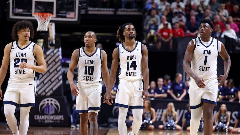 Utah State's Javon Jackson (22), Darius Brown II (10), Josh Uduje (14) and Great Osobor (1) walk downcourt near the end of the team's game against San Diego State in the semifinals of the Mountain West Conference men's tournament Friday, March 15, 2024, in Las Vegas. San Diego State won 86-70.