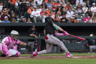 Arizona Diamondbacks' Corbin Carroll, right, hits during a baseball game against the Baltimore Orioles, Sunday, May 12, 2024, in Baltimore. (AP Photo/Jose Luis Magana)