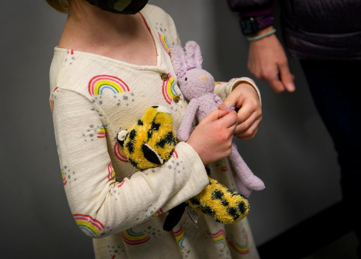 Ellie Buchanan holds Spot the cheetah and Ballerina Bunny Tuesday as she brings them in for repair at the Stuffy Repair Clinic at the Monroe County Humane Association.