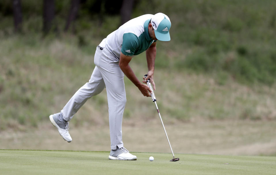 Sergio Garcia reaches to pick up his ball after he missed his second putt on No. 7 during quarterfinal play against Matt Kuchar at the Dell Technologies Match Play Championship golf tournament, Saturday, March 30, 2019, in Austin, Texas. Garcia had an 8-foot putt to win the hole and left it 4 inches short, a frustrating miss. Worse yet was what followed. Such a tap-in typically is conceded in the Dell Technologies Match Play, and the Spaniard walked up and casually rapped it left-handed. The ball spun around the cup, and he picked it up and walked off the green, assuming he remained 1 down through seven holes. One problem: Matt Kuchar never formally conceded the putt. (AP Photo/Eric Gay)