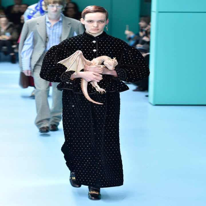 Model carrying a baby dragon