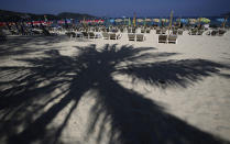 In this March 13, 2014 photo, tourists spend time on Patong Beach in Phuket province, southern Thailand. Thailand’s sapphire blue waters, wildlife parks, delicious cuisine and raunchy red light districts have attracted tourists for decades. Phuket is one of Thailand’s tourism honeypots. Tourists flock here in droves each year for its sun, sand and laid back ambience. And some lose their passports along the way. (AP Photo/Sakchai Lalit)