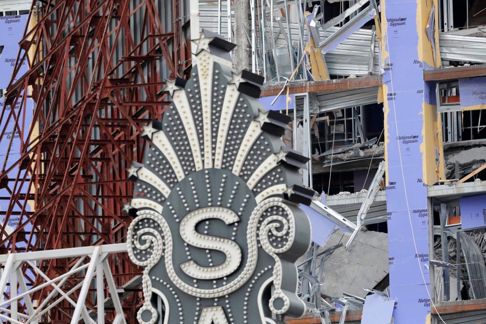 The Saenger Theater sign is seen in the foreground of the damaged Hard Rock Hotel in New Orleans. The 18-story hotel project that was under construction collapsed last Saturday, killing three workers. Two bodies remain in the wreckage.