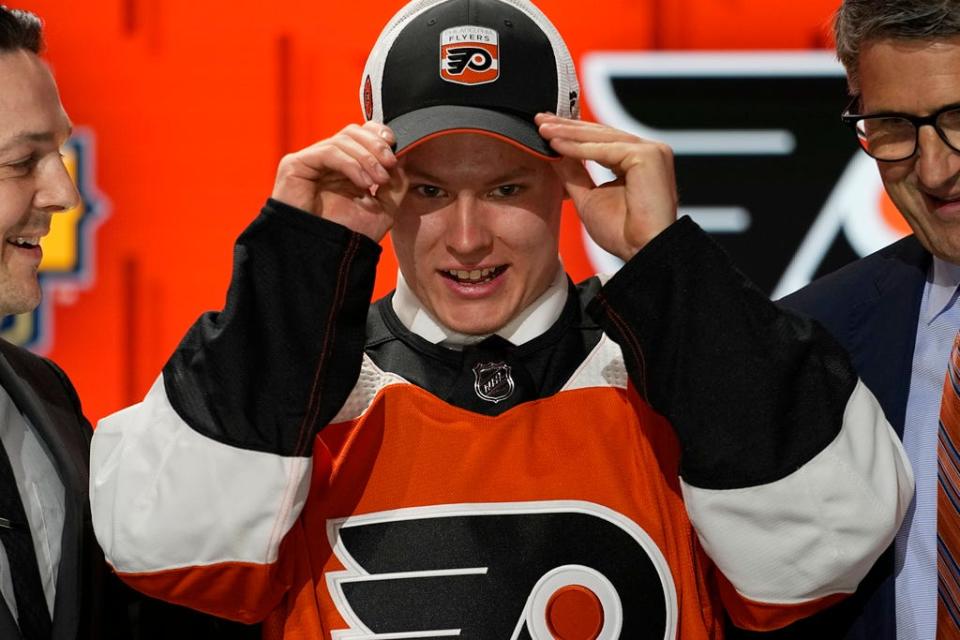 Matvei Michkov adjusts his Philadelphia Flyers hat after being picked by the team during the first round of the NHL hockey draft Wednesday, June 28, 2023, in Nashville, Tenn.  (AP Photo/George Walker IV)