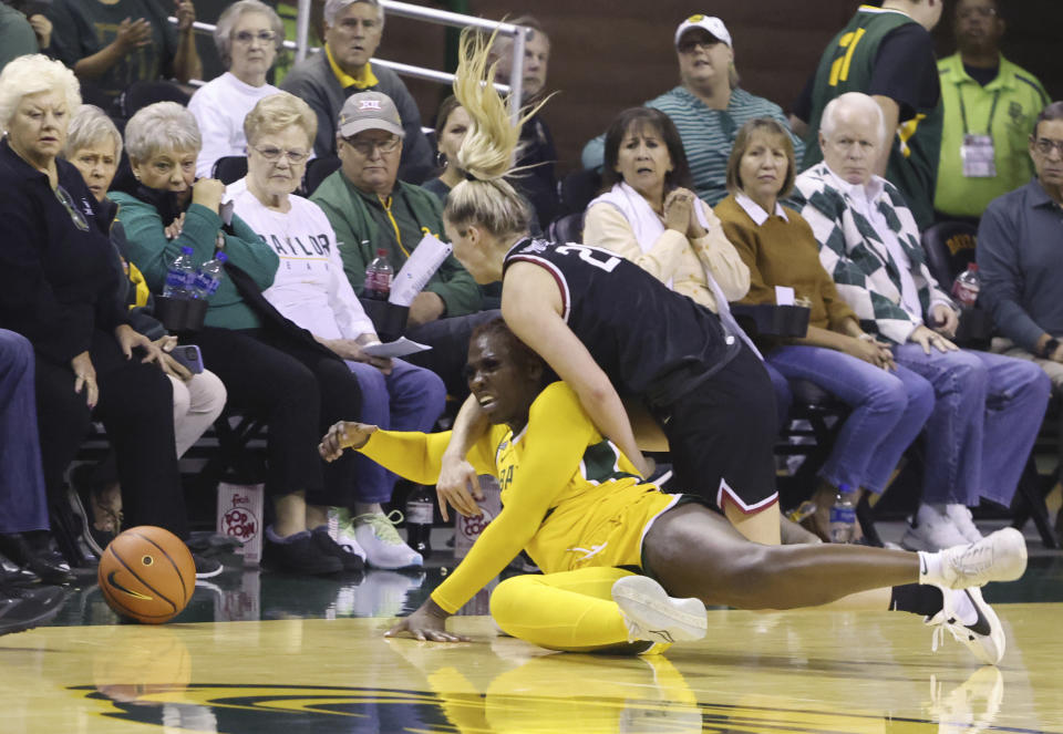 Baylor guard Aijha Blackwell battles Harvard guard Lola Mullaney for a loose ball in the second half of an NCAA college basketball game, Sunday, Nov. 19, 2023, in Waco, Texas. (Rod Aydelotte/Waco Tribune-Herald via AP)