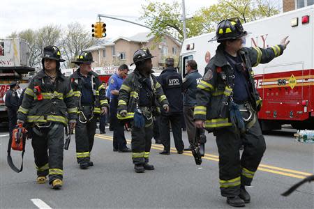 New York City firefighters attend an emergency after an F train derailed in Woodside, New York, May 2, 2014. REUTERS/Eduardo Munoz