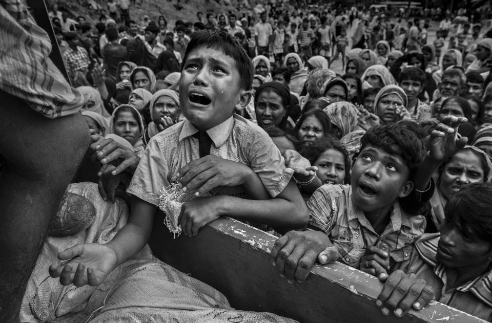 A Rohingya refugee boy desperate for aid cries as he climbs on a truck distributing aid for a local NGO near the Balukali refugee camp on&nbsp;Sept. 20, 2017, in Cox's Bazar, Bangladesh.