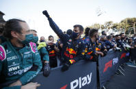 A member of the Red Bull crew cheers as Red Bull driver Sergio Perez of Mexico crosses the finish line to win the Formula One Grand Prix at the Baku Formula One city circuit in Baku, Azerbaijan, Sunday, June 6, 2021. (Maxim Shemetov, Pool via AP)