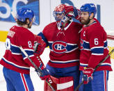 Montreal Canadiens goaltender Carey Price (31) is congratulated by Ben Chiarot (8) and Shea Weber (6) after the team's win over the Ottawa Senators in an NHL hockey game Tuesday, March 2, 2021, in Montreal. (Ryan Remiorz/The Canadian Press via AP)