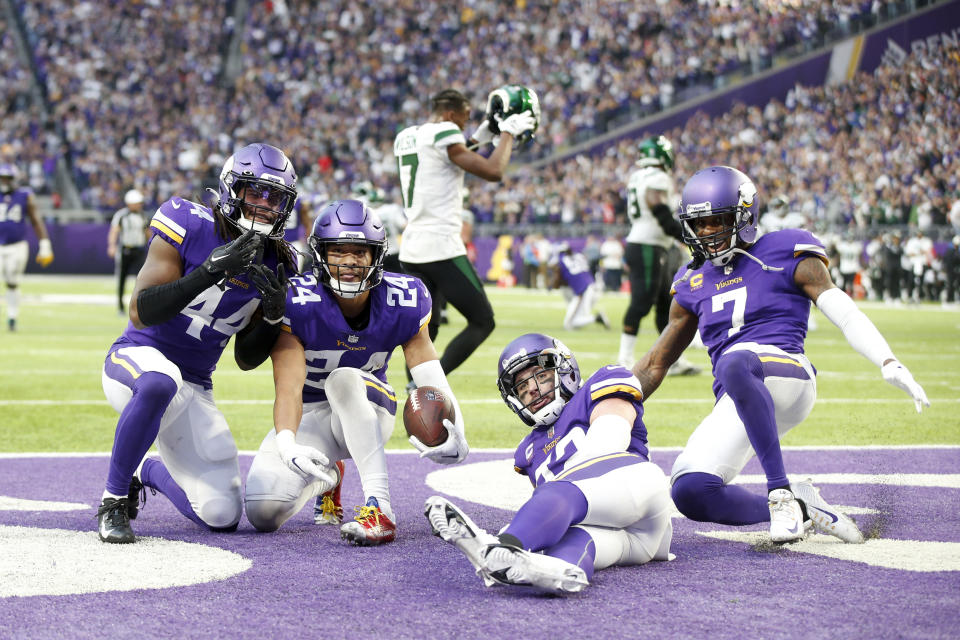 Minnesota Vikings safety Camryn Bynum (24) celebrates with teammates after intercepting a pass during the second half of an NFL football game against the New York Jets, Sunday, Dec. 4, 2022, in Minneapolis. The Vikings won 27-22. (AP Photo/Bruce Kluckhohn)