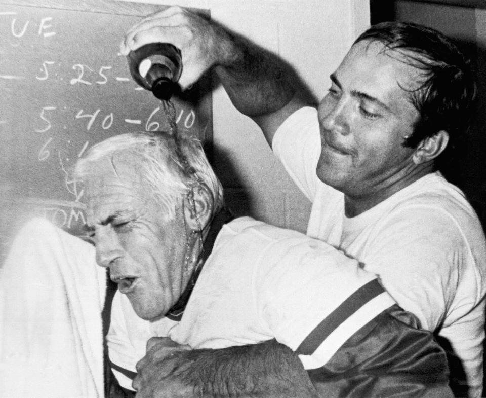 Cincinnati Reds catcher Johnny Bench, right, pours champagne over Reds manager Sparky Anderson after winning the National League West Division title on Sept. 21, 1976.