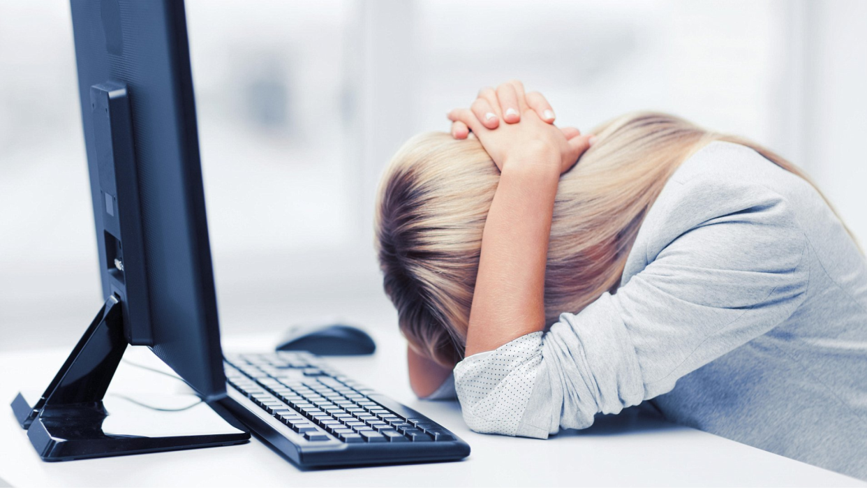  Woman stressed at computer. 