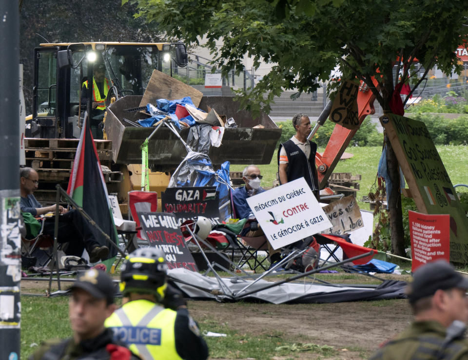 Private security workers dismantle the encampment on McGill University campus Wednesday, July 10, 2024, in Montreal. (Ryan Remiorz/The Canadian Press via AP)