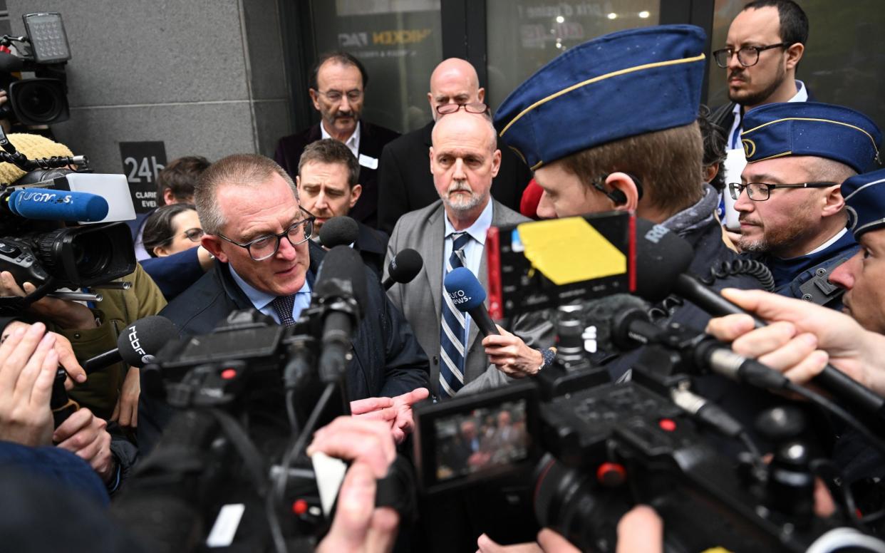 Anthony Gilland (left) speaks to the press after police try to shut down the event