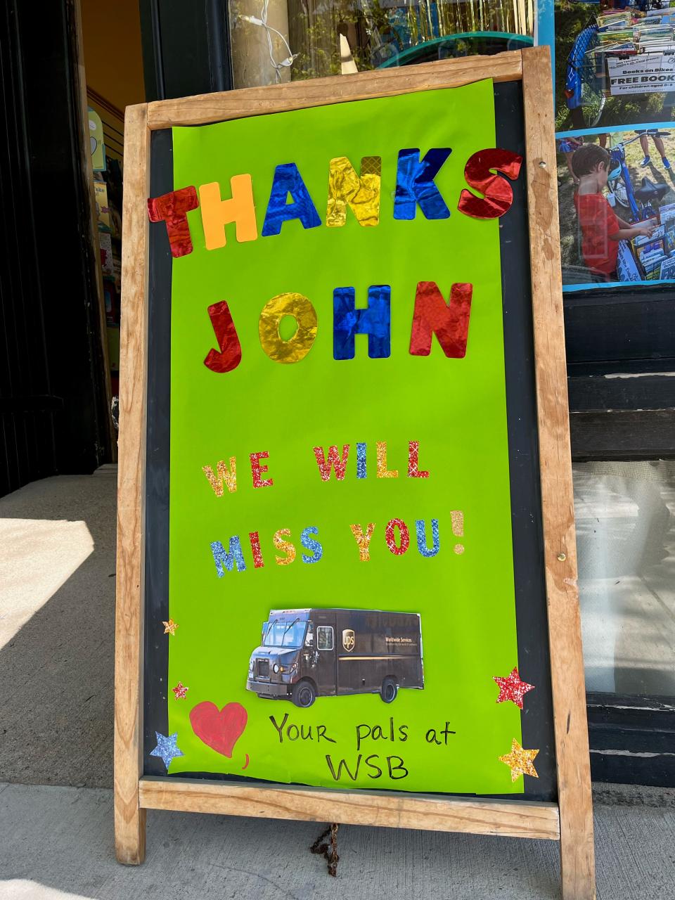 Local businesses on Water Street put up signs for John Hartz in honor of his last day on Friday, May 26.